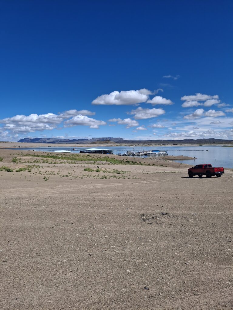 Elephant Butte Lake marina view under a bright blue sky with scattered clouds